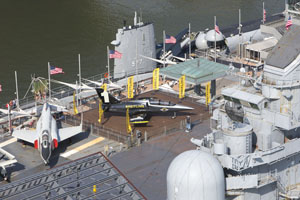 A Breitling Aerobatic Team L-39 aircraft surrounded by yellow Breitling flags sits on the deck of the Intrepid Sea Air and Space Museum in New York City May 25, 2016